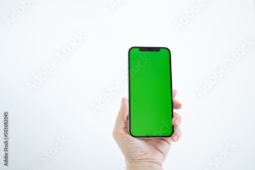 green screen on phone in woman hand, white background