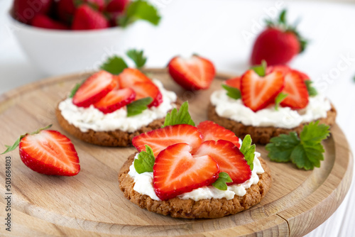 Homemade healthy crispbread bruschetta with strawberry and cream cheese. Healthy snack, keto diet or dieting concept. Recipe of vegan food for everyday cooking.