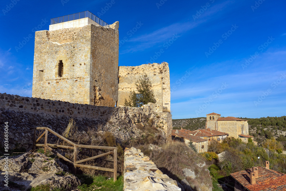 View of the castle of the medieval village of Calatañazor and the church in a sunny day, Soria, Castilla y Leon, Spain.