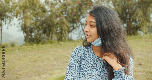 Indian young girl in a facial mask talking photo