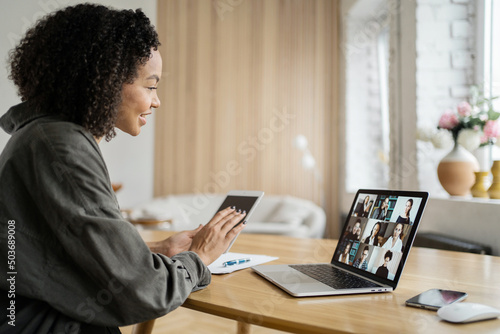 Online video communication with colleagues laptop screen in the office