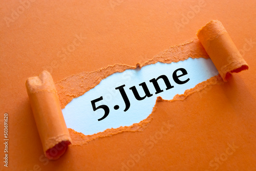 Calendar date. June 5 written under torn paper. photo