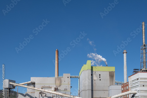 Factory Smokestack Against Blue Sky
