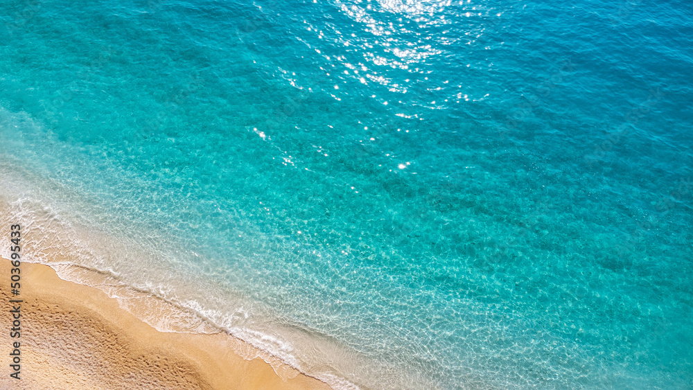 Aerial view of beautiful sandy beach and soft turquoise ocean wave. Tropical sea in summer season on Porto Katsiki beach on Lefkada island.