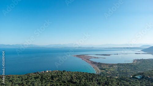Aerial view of Agios Ioannis beach in Lefkada island in Greece. In front are the olive trees and in distance is mainland.