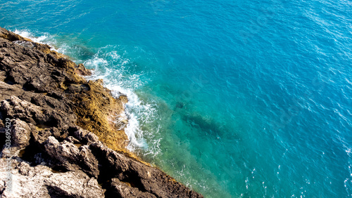 Aerial view of sea hitting the rocks on Porto Katsiki beach. Tropical turquoise sea in summer season on Lefkada island.