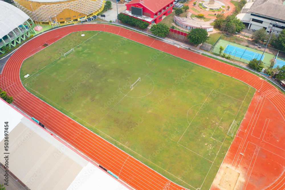 Obraz premium Aerial top view of rubber floor, red running track on a sports stadium with grandstand. Sport and recreation background.