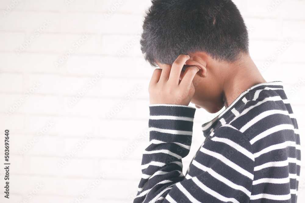 teenage boy having ear pain touching his painful ear , teenage boy having ear pain touching his painful ear ,
