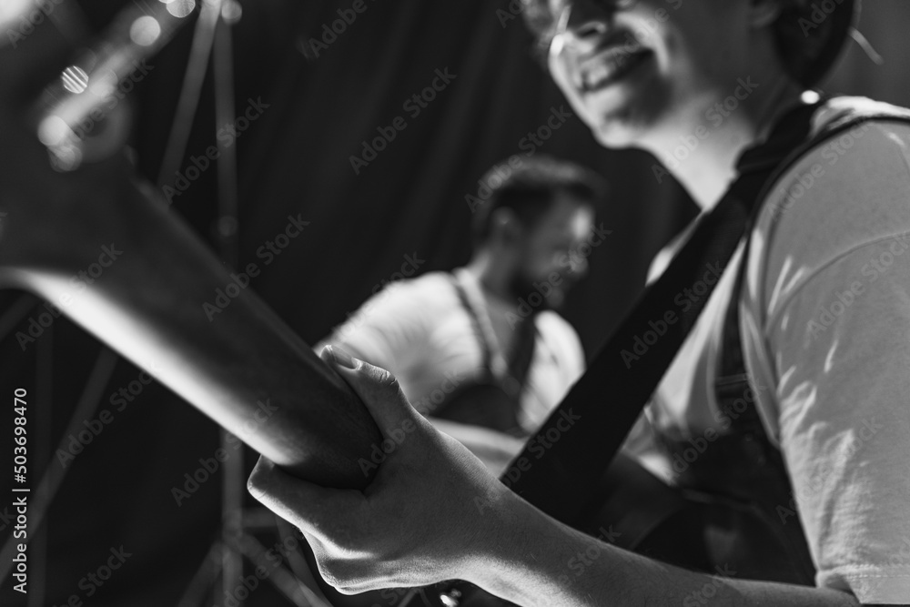 Repetition of rock music band at music studio. Cropped image of electric and acoustic guitar players at concert. Rehearsal base Concept of art, music, style