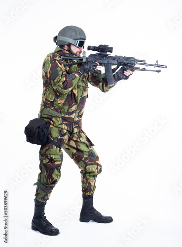 military man standing and aiming with a rifle isolated