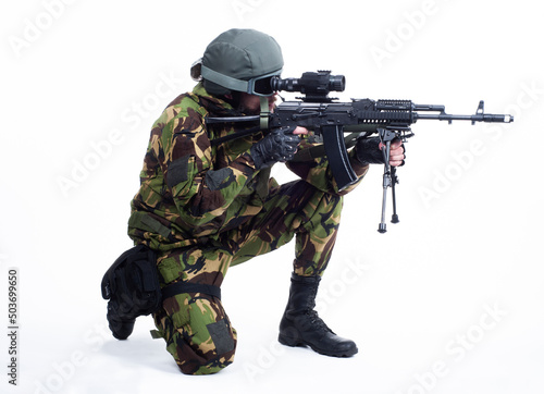 military man standing on one knee and aiming with a rifle isolate