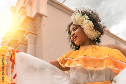 Traditional curly-haired mestizo dancer with a typical Nicaraguan costume dancing outside the cathedral of Leon Nicaragua celebrating the independence festivities of Central America.