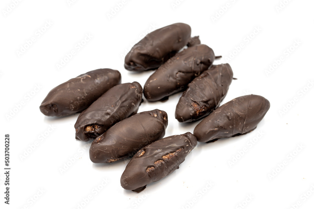 Special chocolate with dark outside and coconut inside. Dark chocolate with coconut filling on a white background. close up Special chocolate with dark outside and coconut inside. Dark chocolate with coconut filling on a white background. close up