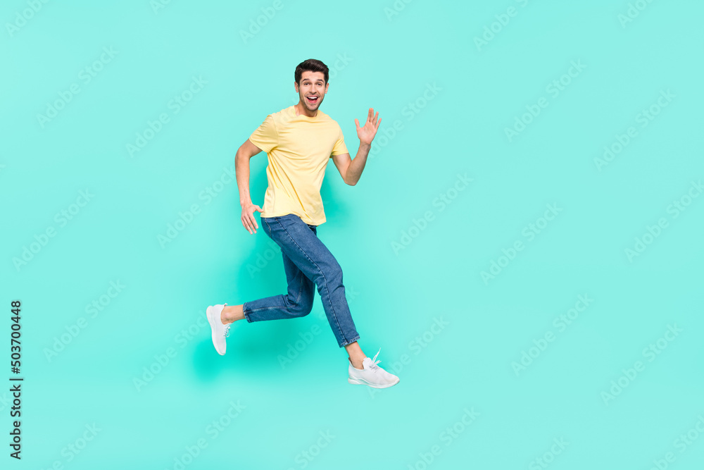 Full body profile portrait of excited energetic man running hurry speed isolated on teal color background Full body profile portrait of excited energetic man running hurry speed isolated on teal color background