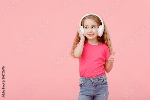 cute sweet tender adorable girl listening to favorite song using headphones isolated on pink background. Style playlist leisure lifestyle weekend positive glamour concept.