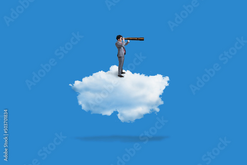 business man standing on clouds and using telescope on blue background, business concept photo