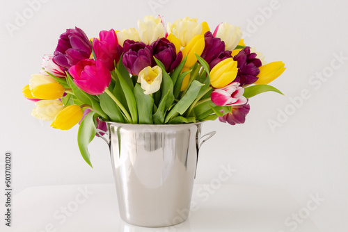 Fototapeta Naklejka Na Ścianę i Meble -  Bright colorful natural background with fresh tulips, spring flowers, yellow, pink colors shooted above white background