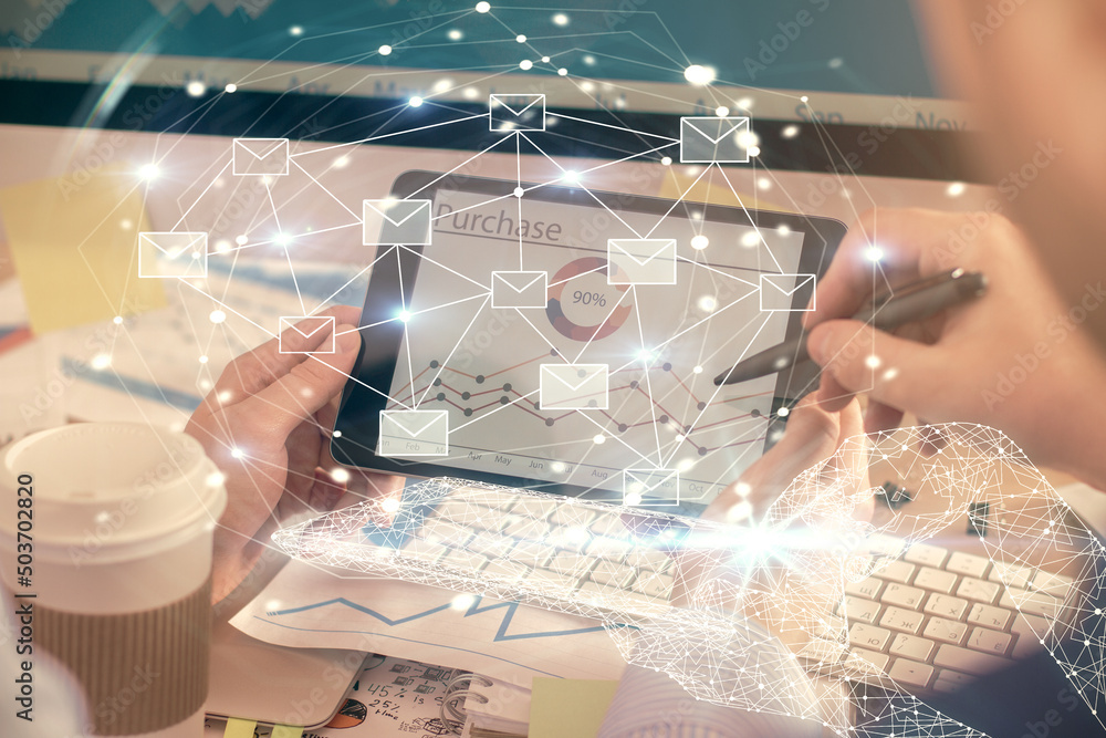 Double exposure of man's hands holding and using a digital device and envelop hologram drawing. E-mail concept. Double exposure of man's hands holding and using a digital device and envelop hologram drawing. E-mail concept.