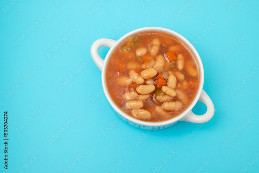 boiled white beans with vegetables and sauce on white bowl boiled white beans with vegetables and sauce on white bowl