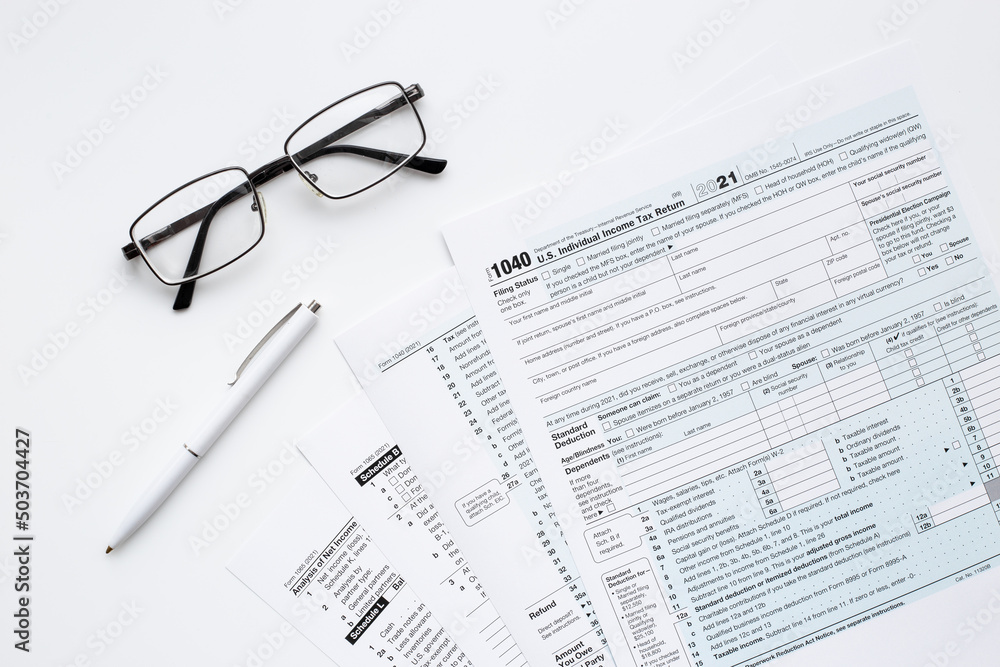 Pen on US individual tax form. Tax payment season Pen on US individual tax form. Tax payment season