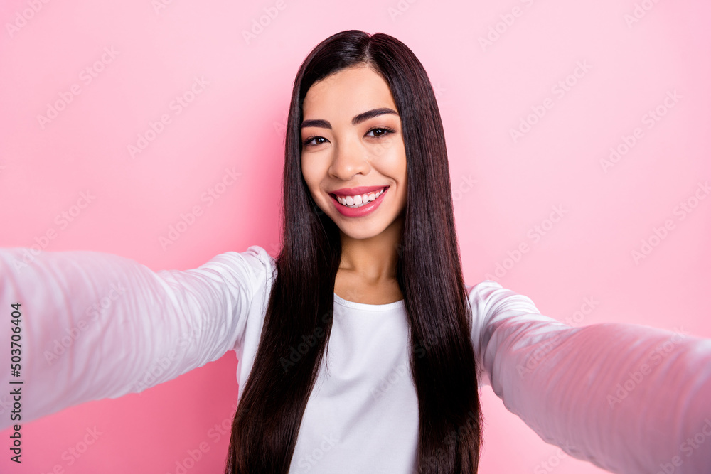 Photo of nice millennial brunette lady do selfie wear white shirt isolated on pink color background Photo of nice millennial brunette lady do selfie wear white shirt isolated on pink color background