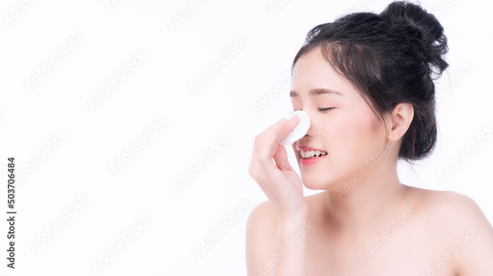 Portrait smile asian woman using white cotton pad cleaning on own face for removing make-up on isolated on white background. Glamour lady holding cotton pad on nose with copy space. Cosmetics concept. Portrait smile asian woman using white cotton pad cleaning on own face for removing make-up on isolated on white background. Glamour lady holding cotton pad on nose with copy space. Cosmetics concept.