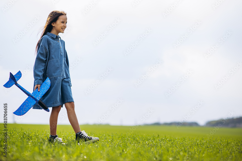 Little girl playing with toy plane in the field Little girl playing with toy plane in the field