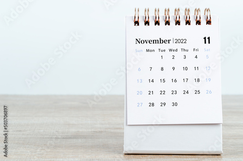 November 2022 desk calendar on wooden background. photo