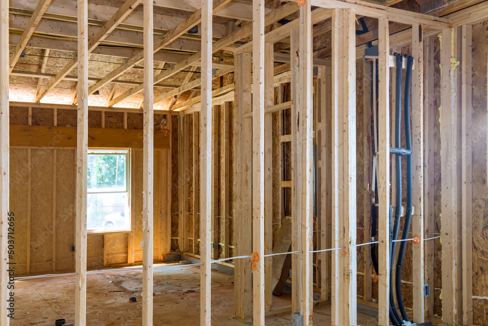 Obraz premium Wooden beams and wall to ceiling framed building under construction interior residential home