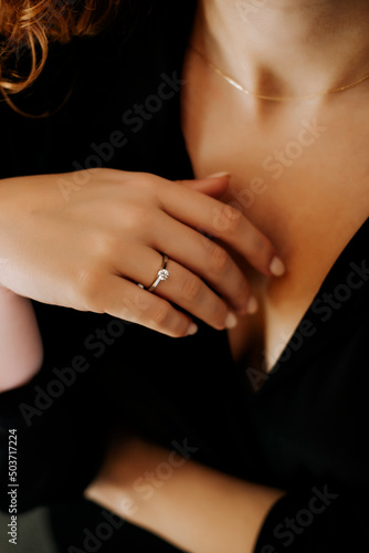 Close up of a blurred ring on woman's finger.Wedding and love concept.