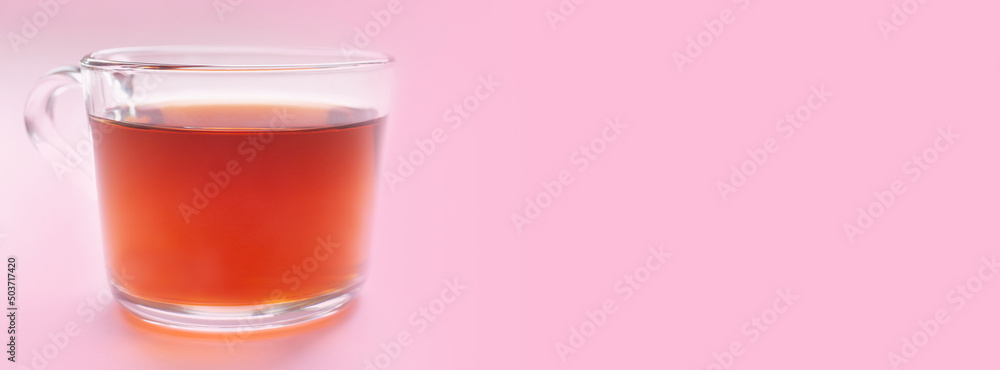 Banner with a cup of black tea on a pink background. Place for text. Copy space. Banner with a cup of black tea on a pink background. Place for text. Copy space.