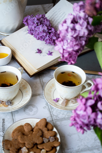 cup of tea on a books with flowers