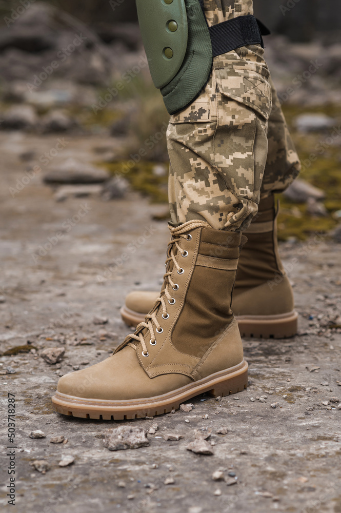 A soldier shod in special tactical khaki shoes A soldier shod in special tactical khaki shoes