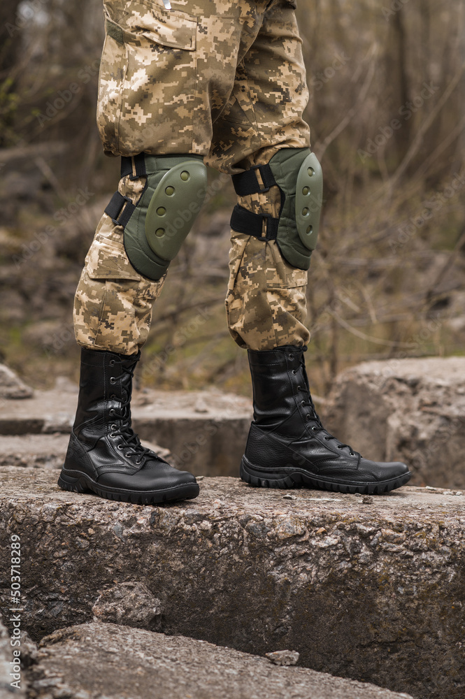 Military man in black leather tactical boots Military man in black leather tactical boots