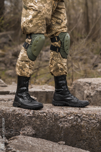 Military man in black leather tactical boots