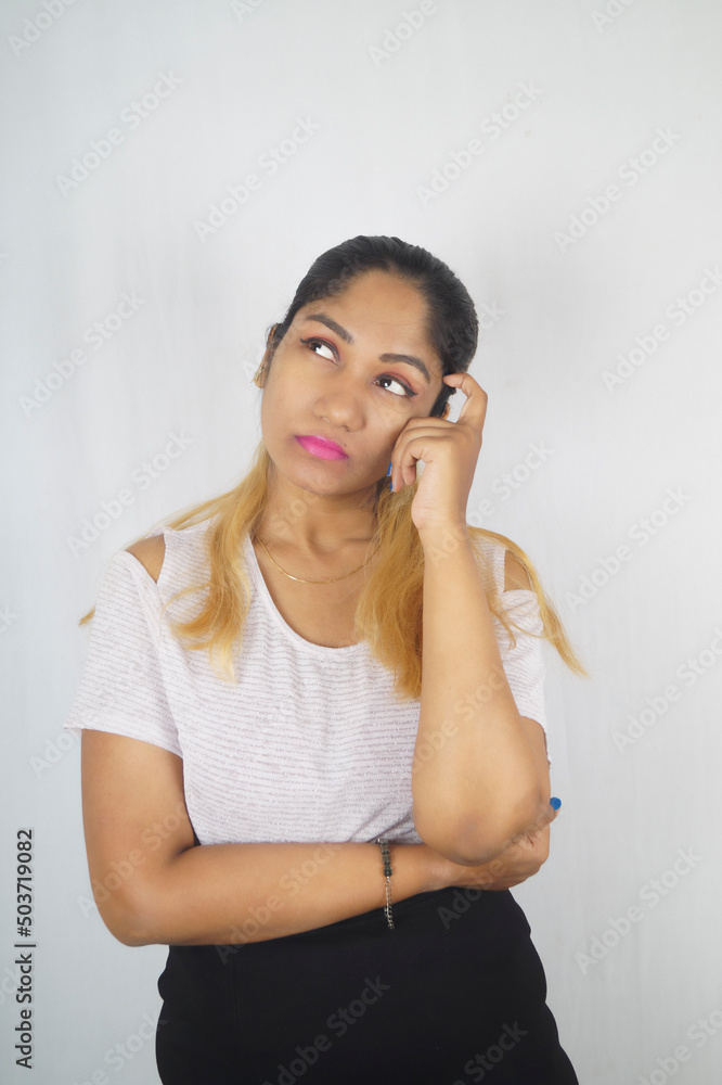 Thoughtful woman looking up in front of white background Thoughtful woman looking up in front of white background
