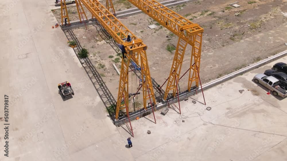 Crane Without Rope Construction workers climbing on top of crane rail-mounted gantry ...