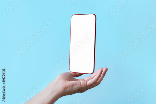 Bild auf Leinwand Smartphone floating in palm of hand supports with a blank display screen , Mobil