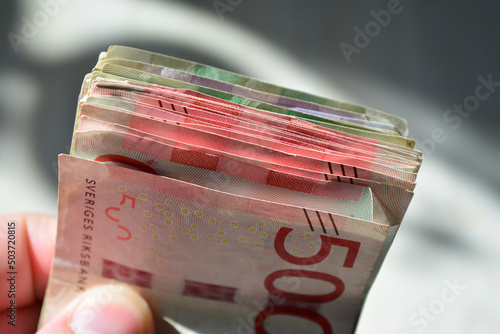 Close-up shot of Swedish currency in cash bills in a hand photo