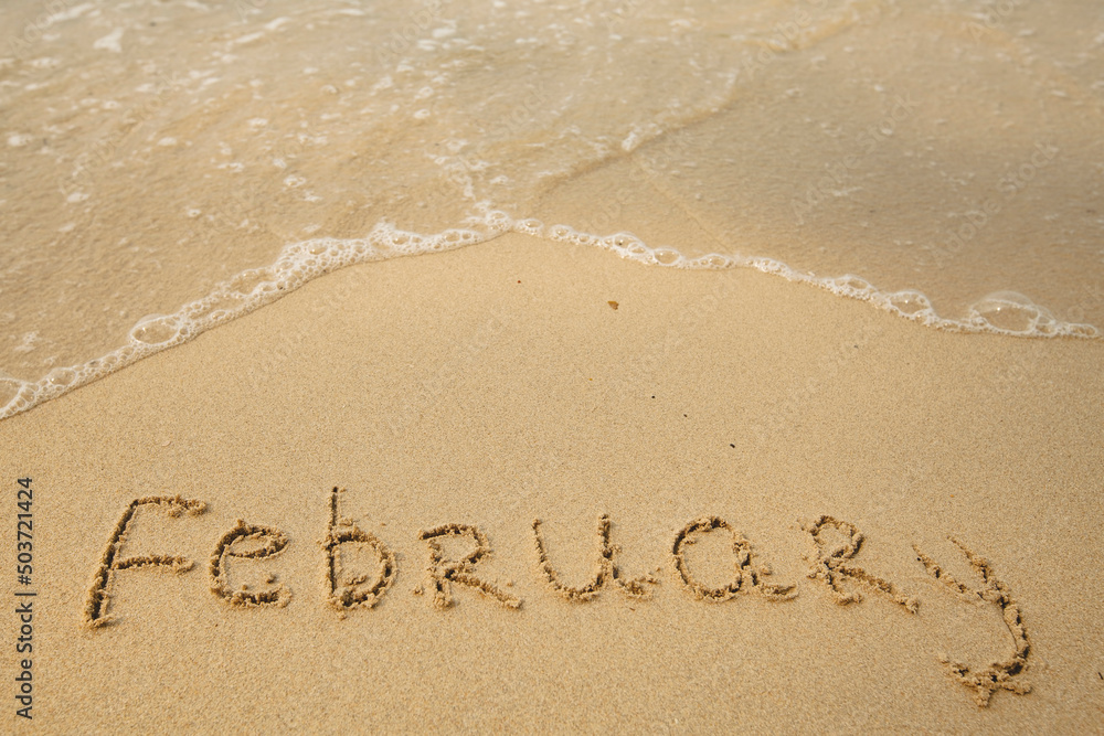 February - drawing on the soft beach sand with a soft lapping wave. February - drawing on the soft beach sand with a soft lapping wave.