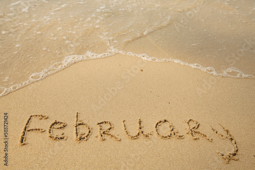 February - drawing on the soft beach sand with a soft lapping wave.