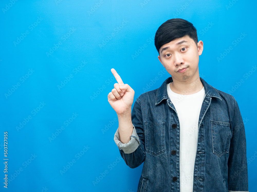 Handsome man jean shirt gesture point finger at copy space Handsome man jean shirt gesture point finger at copy space