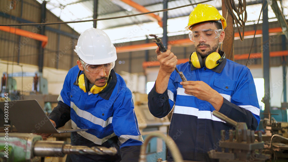 Factory engineer measure steel tube by using vernier caliper. Checking or maintenance machine. Wearing safety helmet and glasses during work. Worker inspector equipment. Industrial and technology Factory engineer measure steel tube by using vernier caliper. Checking or maintenance machine. Wearing safety helmet and glasses during work. Worker inspector equipment. Industrial and technology