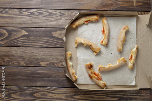 empty pizza box on wooden. Leftover pizza in a box.