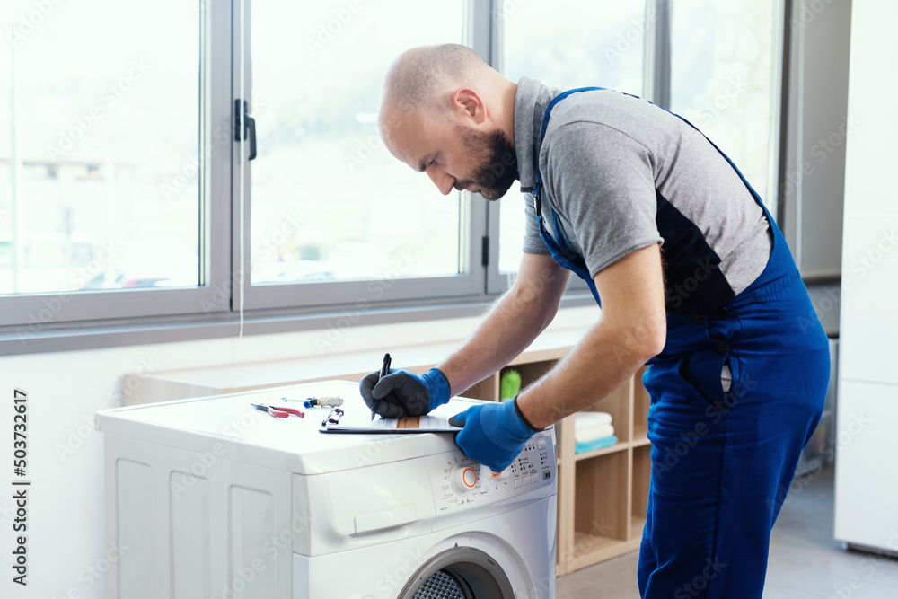 Professional repairman writing an invoice Professional repairman writing an invoice
