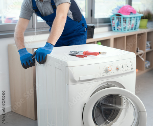 Photography Professional repairman fixing a washer