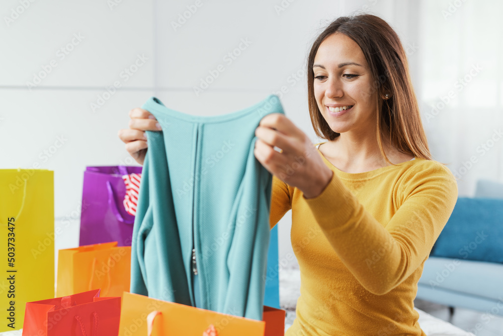 Cheerful woman looking into her shopping bags Cheerful woman looking into her shopping bags