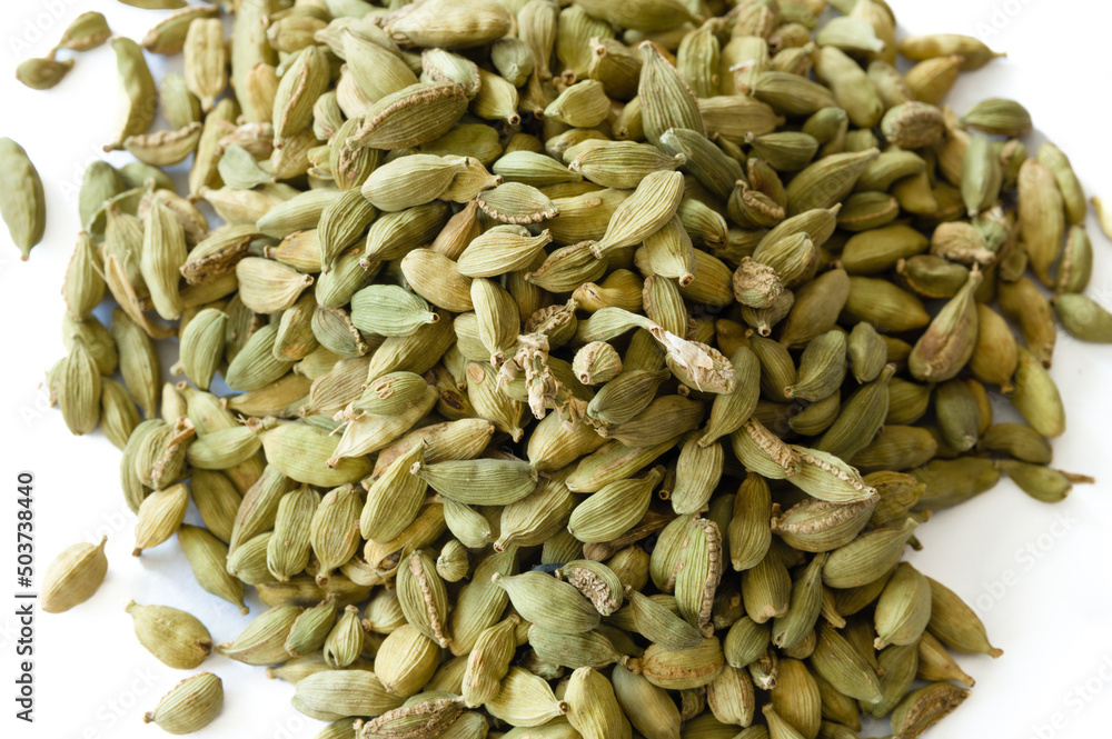 Heap of dry green cardamons on a white background Heap of dry green cardamons on a white background