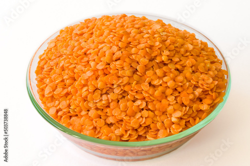 Raw dal in a glass bowl on a white background