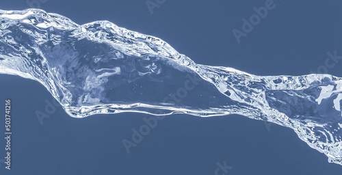 Water splash on a blue background. Reflection on the surface of the water.
